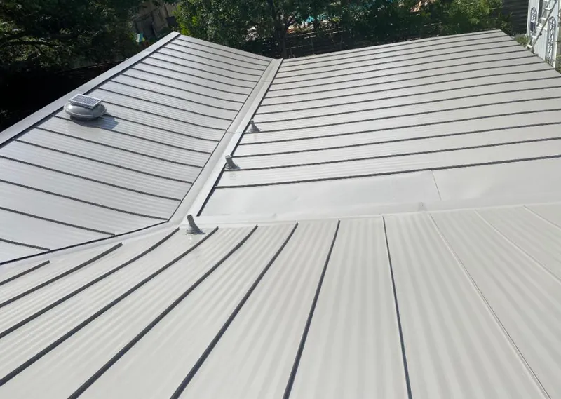 Solar attic fan installed on a metal roof for Roof Ventilation in Hackettstown